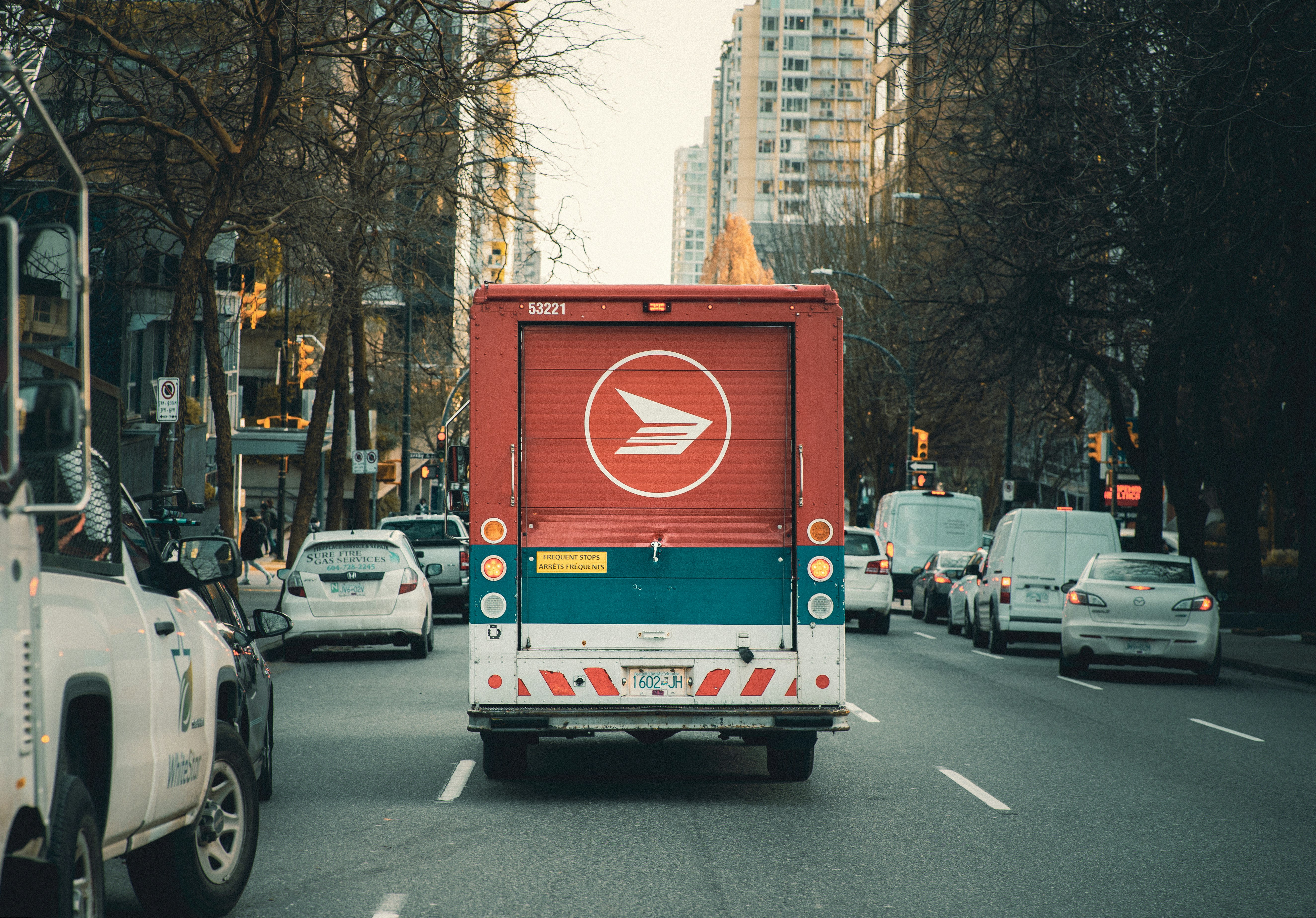 red and white bus on road during daytime